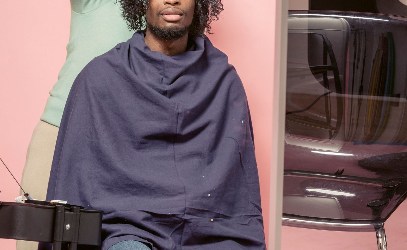 A professional hairstylist working on a customer in a salon